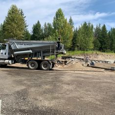 Stone Slinger backfilling Foundation